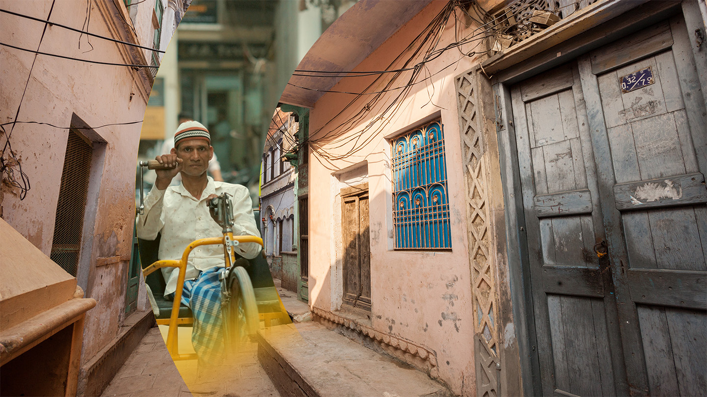 Man in wheelchair overlayed on varanasi street